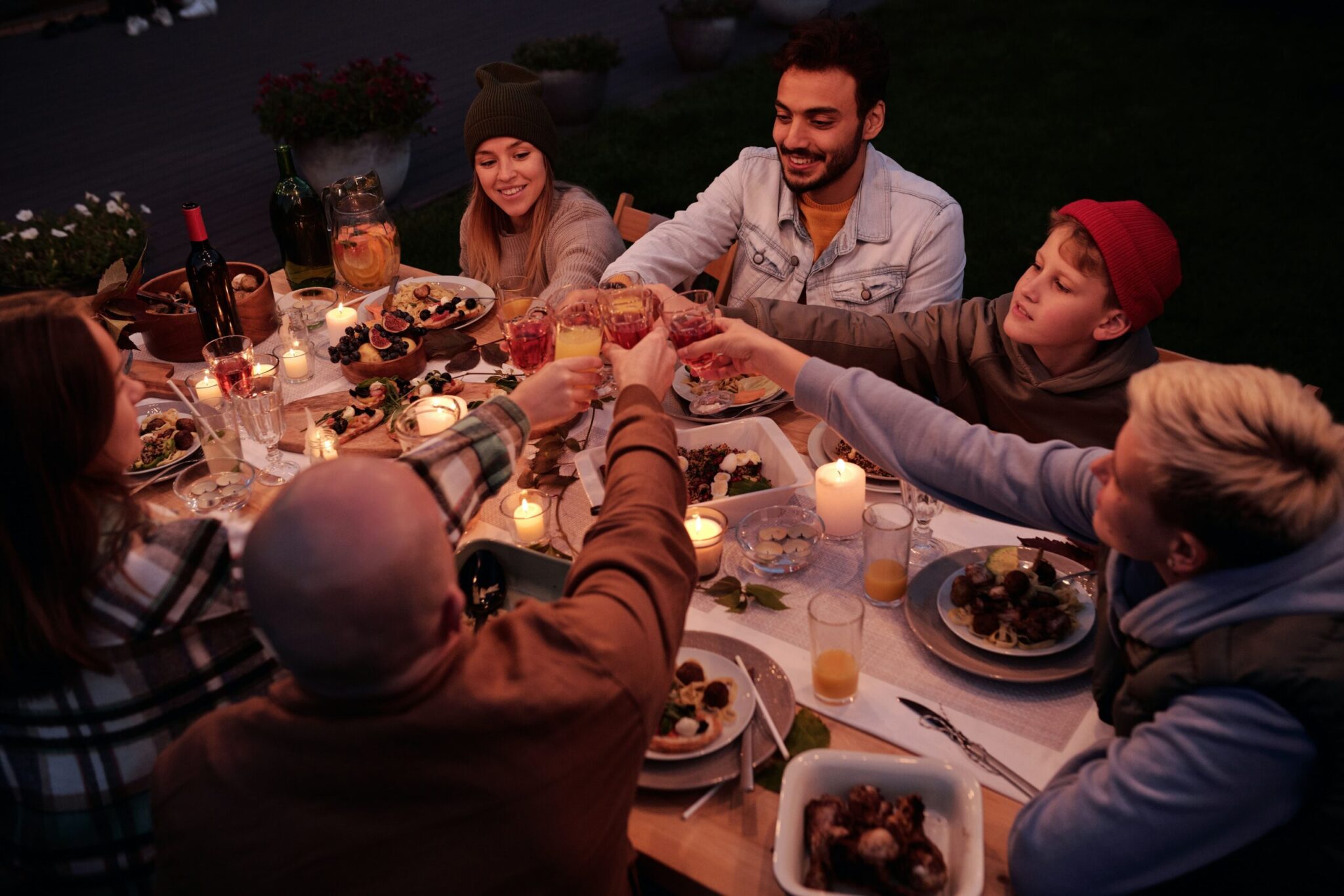 friends toasting while at the bbq dinner table